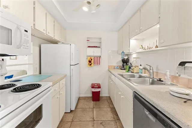 a kitchen with a sink a stove and refrigerator