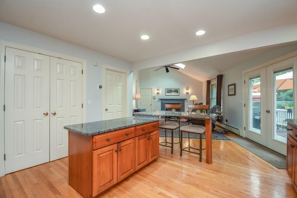 95 Stonefence Road Lunenburg, MA 01462 - Photo 16 of 41 a kitchen with a sink and wooden cabinets