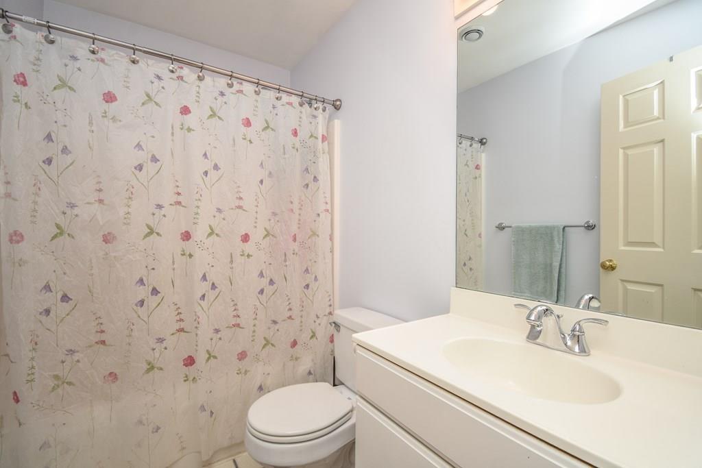 95 Stonefence Road Lunenburg, MA 01462 - Photo 30 of 41 a bathroom with a sink a toilet and shower curtain