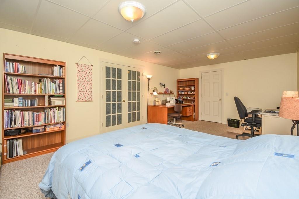 95 Stonefence Road Lunenburg, MA 01462 - Photo 36 of 41 a bedroom with a bed and a book shelf