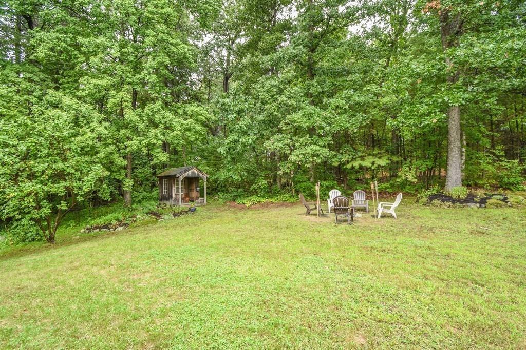 95 Stonefence Road Lunenburg, MA 01462 - Photo 10 of 41 a backyard of a house with table and chairs