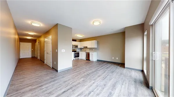 a view of a hallway with wooden floor