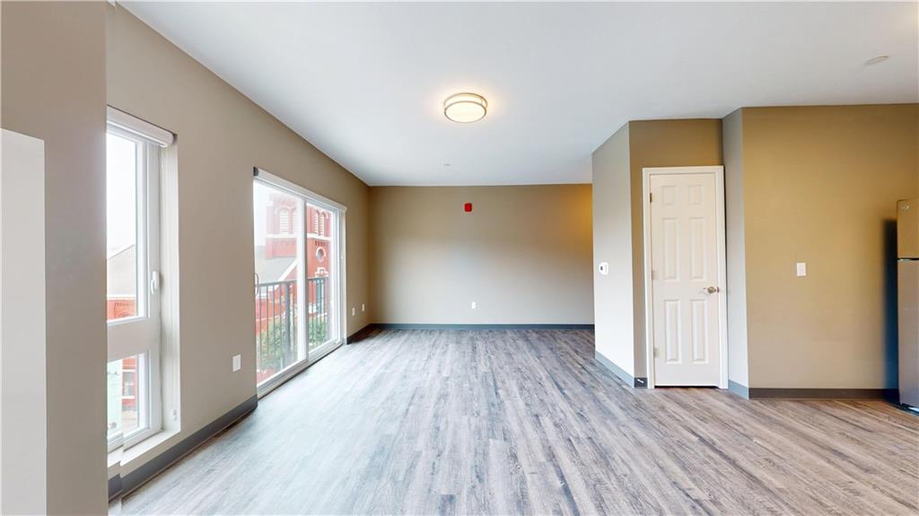1450 Fifth Avenue, Unit 202 Pittsburgh, PA 15219 - Photo 15 of 20 wooden floor in an empty room with a window