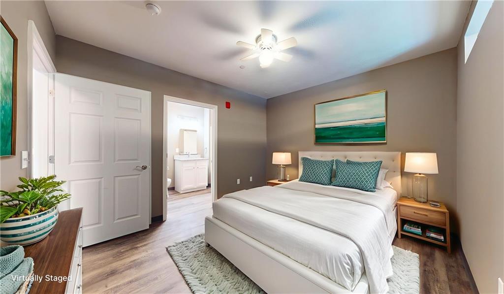 1450 Fifth Avenue, Unit 202 Pittsburgh, PA 15219 - Photo 7 of 20 a bedroom with a bed and a chandelier