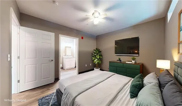 a bedroom with a bed and a flat screen tv