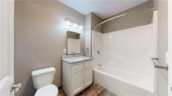 a bathroom with a toilet a sink and bathtub