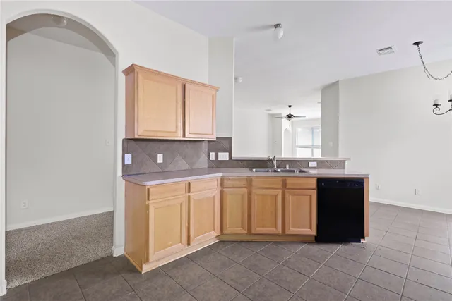 a kitchen with a sink and cabinets
