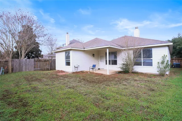 a front view of a house with a garden and yard