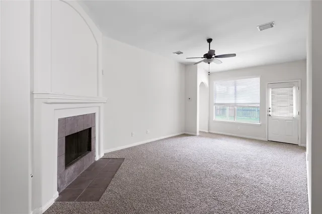 a view of an empty room with a fireplace