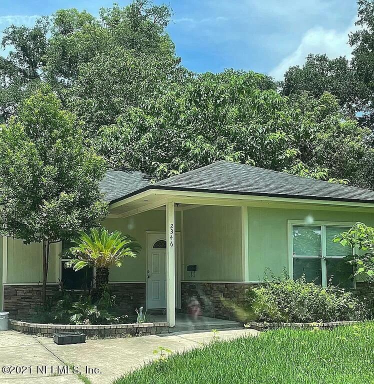 2346 Somerset Road Jacksonville, FL 32210 - Photo 1 of 23 a front view of a house with garden