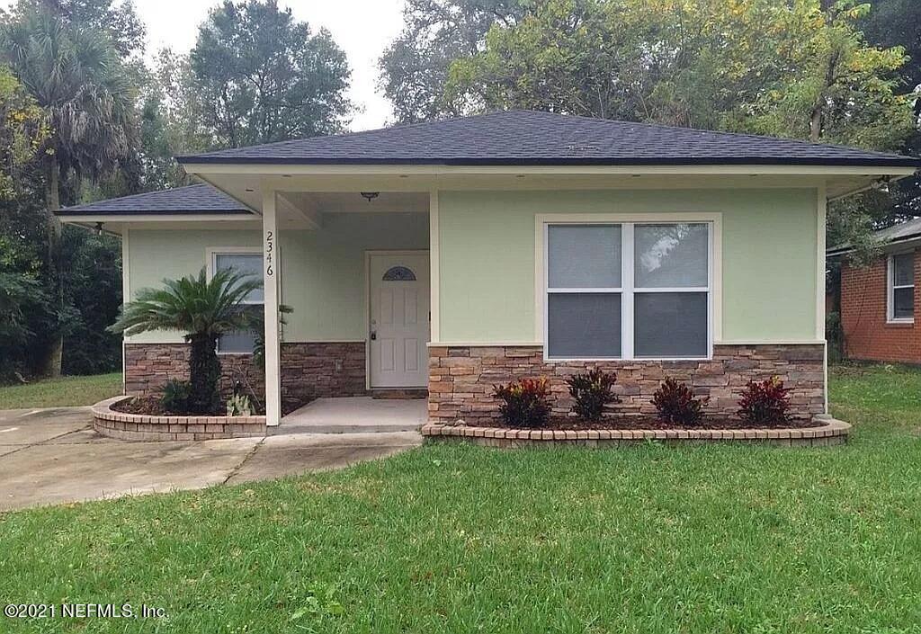 2346 Somerset Road Jacksonville, FL 32210 - Photo 2 of 23 a front view of a house with a garden