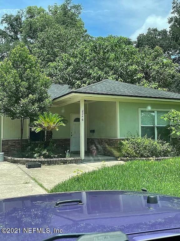 2346 Somerset Road Jacksonville, FL 32210 - Photo 3 of 23 a view of house with outdoor space and tall tree