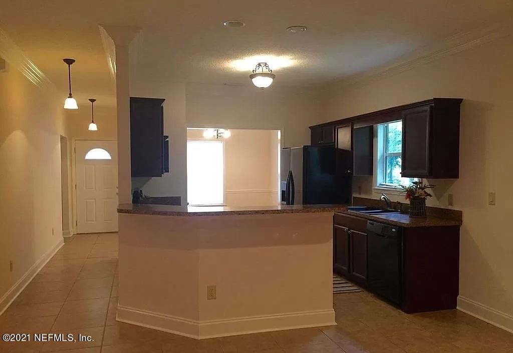2346 Somerset Road Jacksonville, FL 32210 - Photo 6 of 23 a kitchen with granite countertop a sink and cabinets