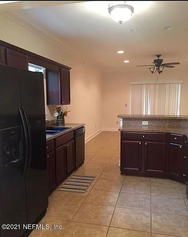 2346 Somerset Road Jacksonville, FL 32210 - Photo 7 of 23 a kitchen with a refrigerator and a sink