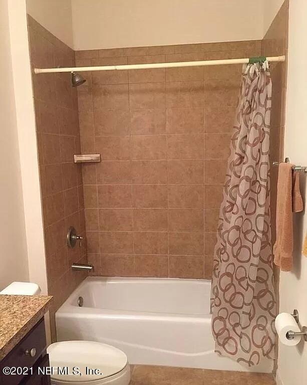 2346 Somerset Road Jacksonville, FL 32210 - Photo 10 of 23 a bathroom with a toilet and shower