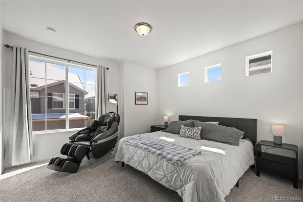a bedroom with a bed and a large window