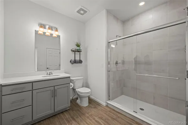 a bathroom with a toilet a sink and shower