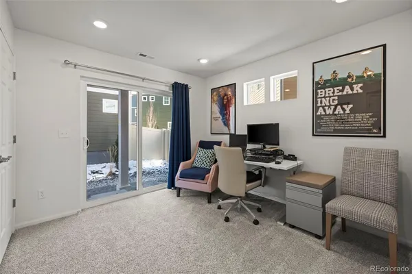a view of a livingroom with workspace and a couch