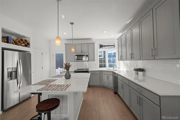 a kitchen with a sink a stove a refrigerator and cabinets
