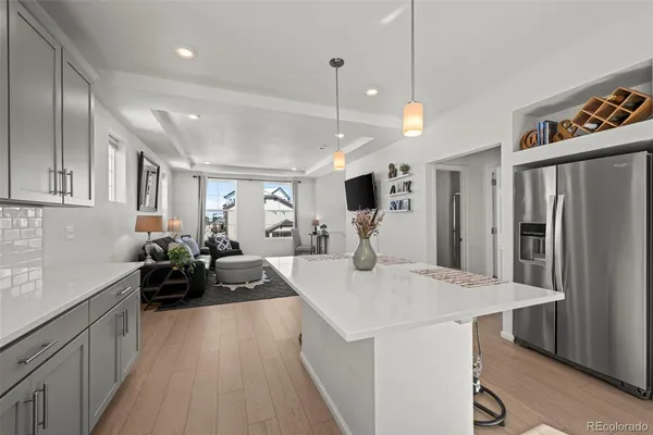 a kitchen with kitchen island a counter top space a sink stainless steel appliances and cabinets