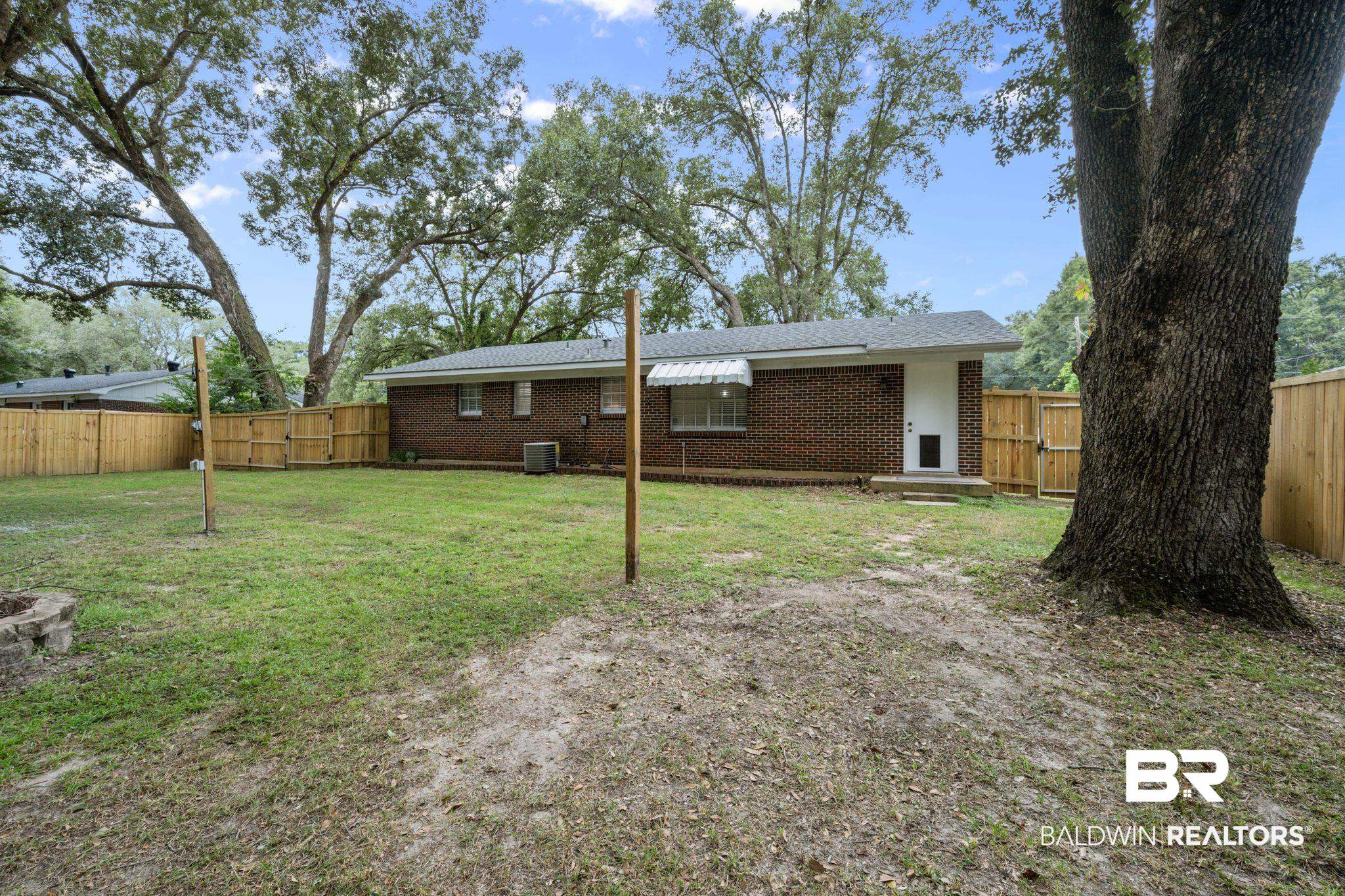621 Ann Street Saraland, AL 36571 - Photo 17 of 21 View of yard featuring central AC