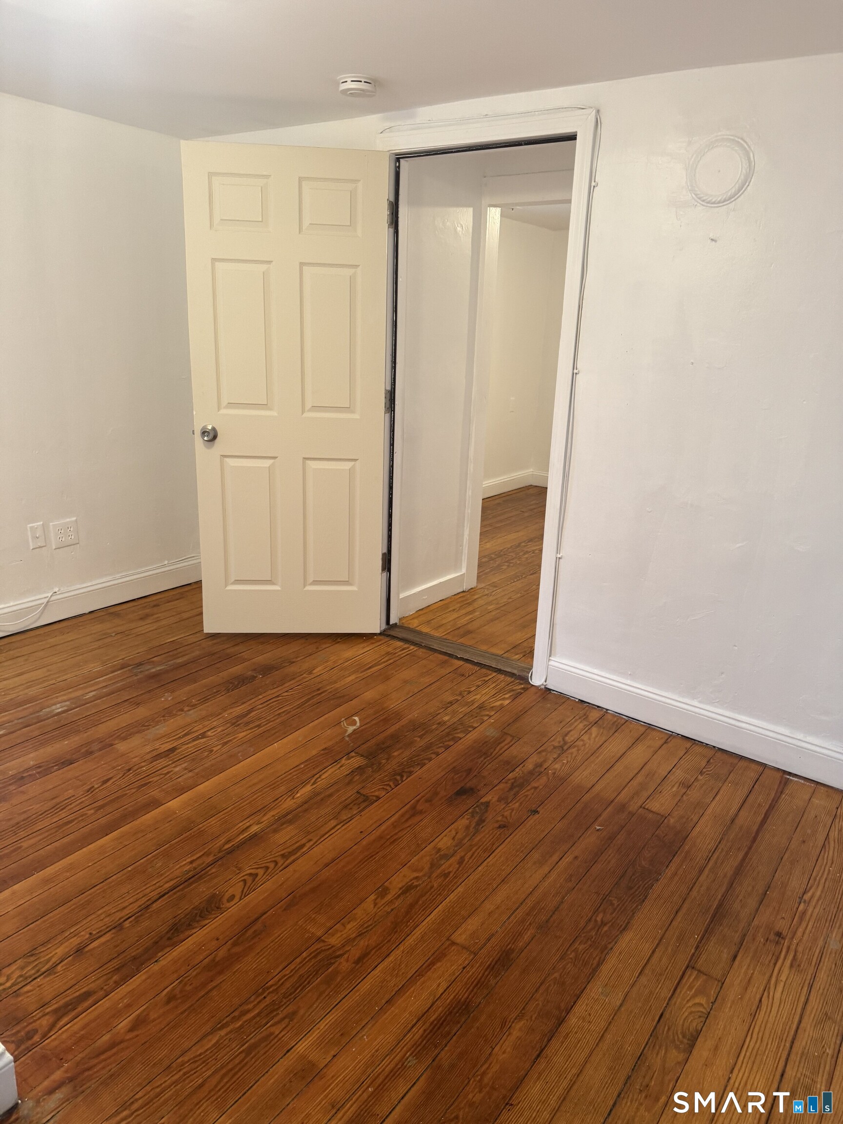 Undisclosed Address Ansonia, CT 06401 - Photo 11 of 20 a view of an empty room with wooden floor