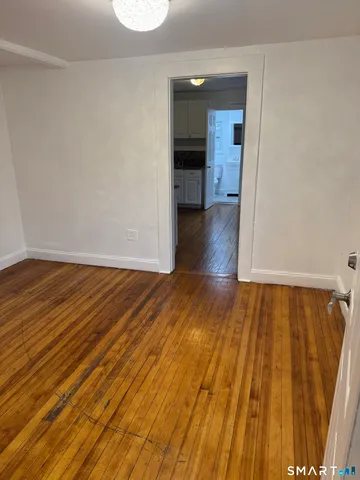 a view of a room with wooden floor and a sink