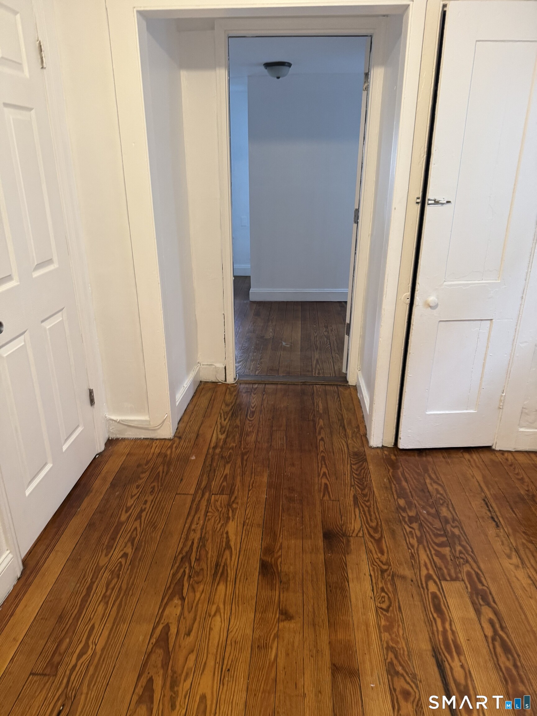 Undisclosed Address Ansonia, CT 06401 - Photo 7 of 20 a view of a room with wooden floor and staircase