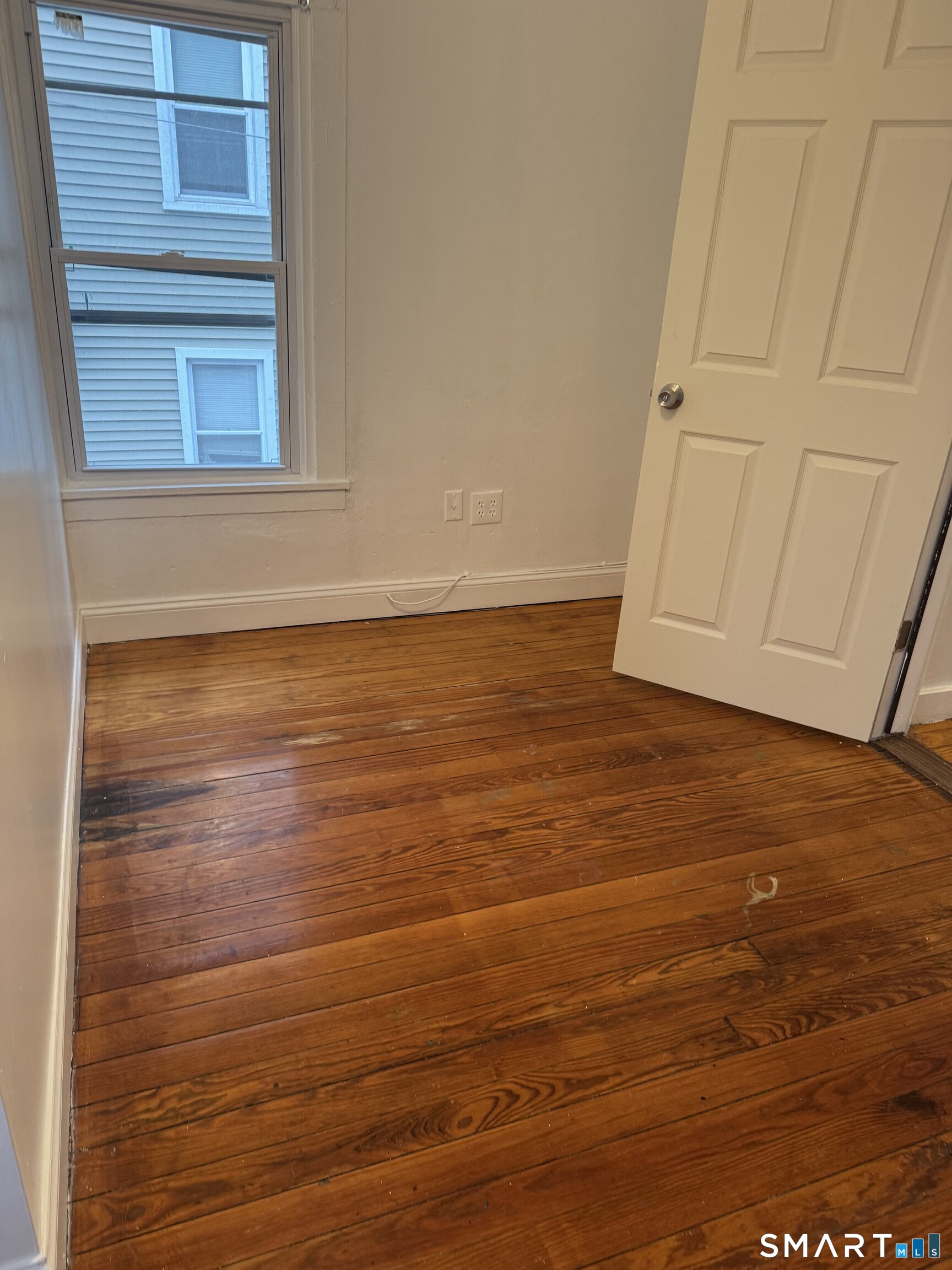 Undisclosed Address Ansonia, CT 06401 - Photo 9 of 20 a view of a room with an empty space and wooden floor
