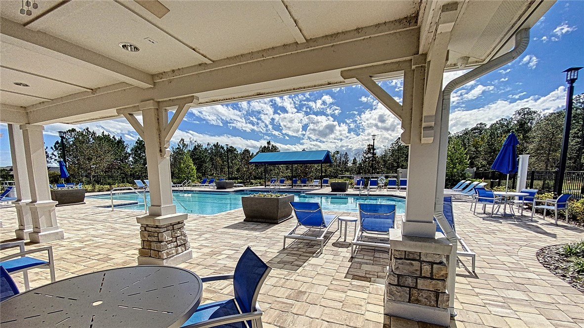 93015 Cope Court Fernandina Beach, FL 32034 - Photo 13 of 23 a view of a patio with couches chairs dining table and chairs barbeque grill with a small yard