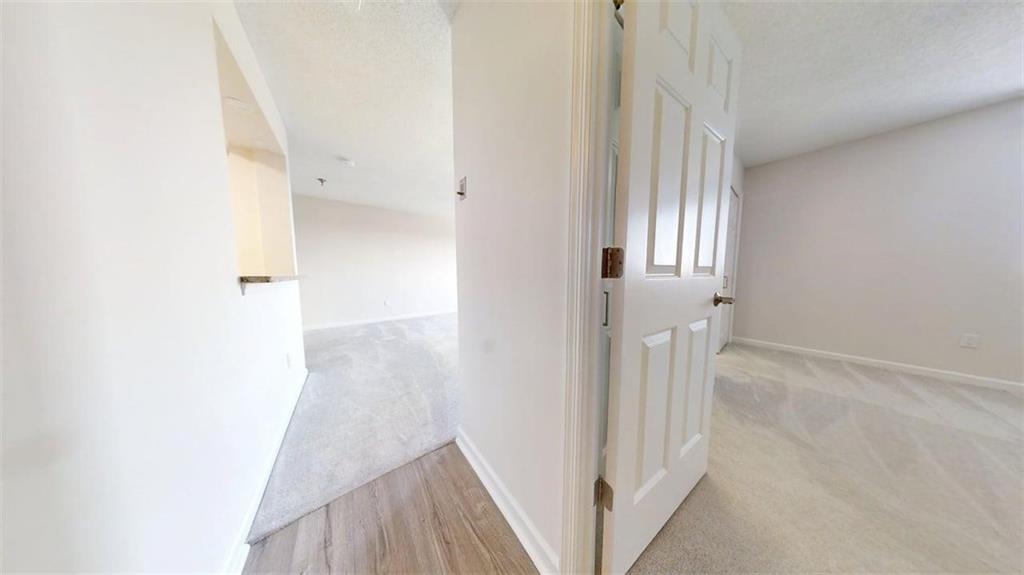 300 Johnson Ferry Road, Unit B805 Sandy Springs, GA 30328 - Photo 20 of 31 a view of a hallway with wooden floor and entryway
