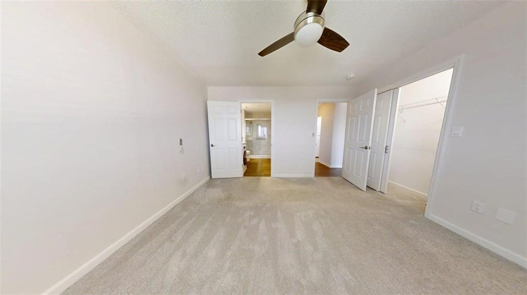 300 Johnson Ferry Road, Unit B805 Sandy Springs, GA 30328 - Photo 23 of 31 an empty room with ceiling fan and windows