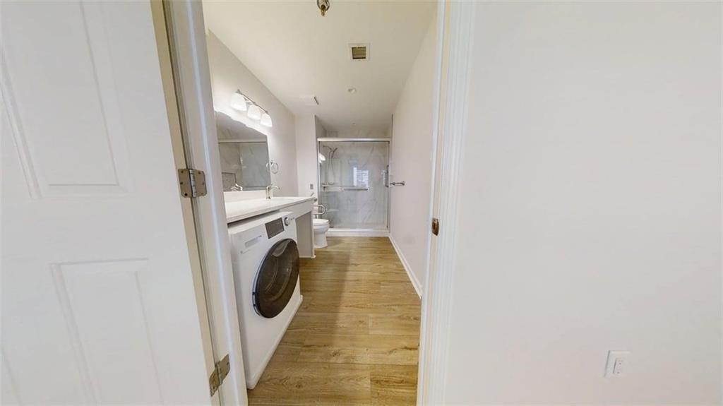 300 Johnson Ferry Road, Unit B805 Sandy Springs, GA 30328 - Photo 24 of 31 a view of a hallway with washer and dryer