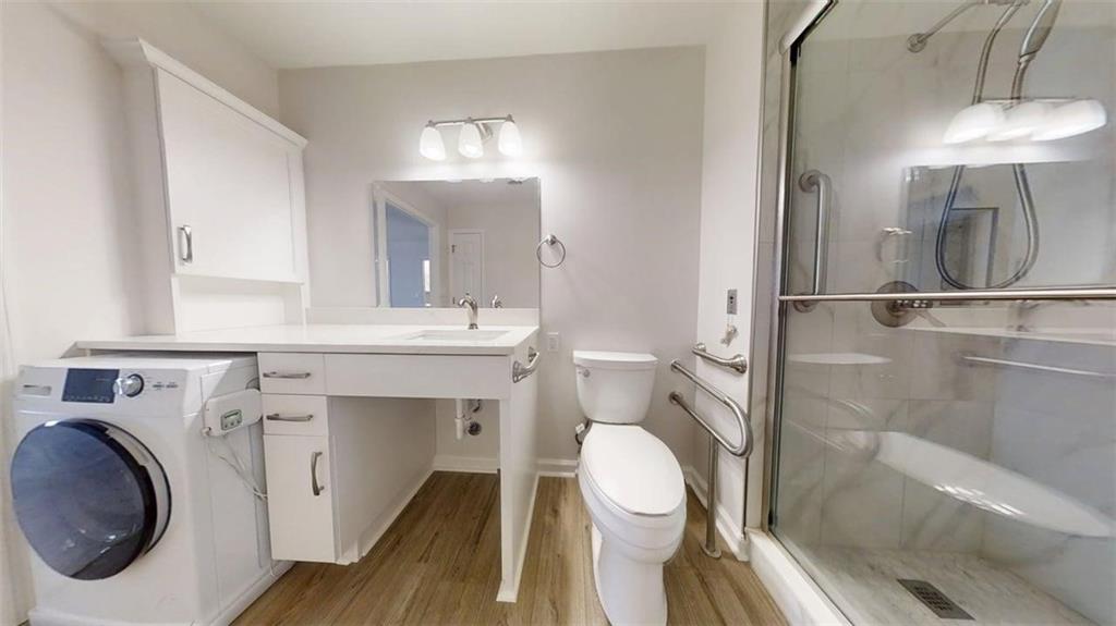 300 Johnson Ferry Road, Unit B805 Sandy Springs, GA 30328 - Photo 26 of 31 a bathroom with a sink a toilet and a mirror