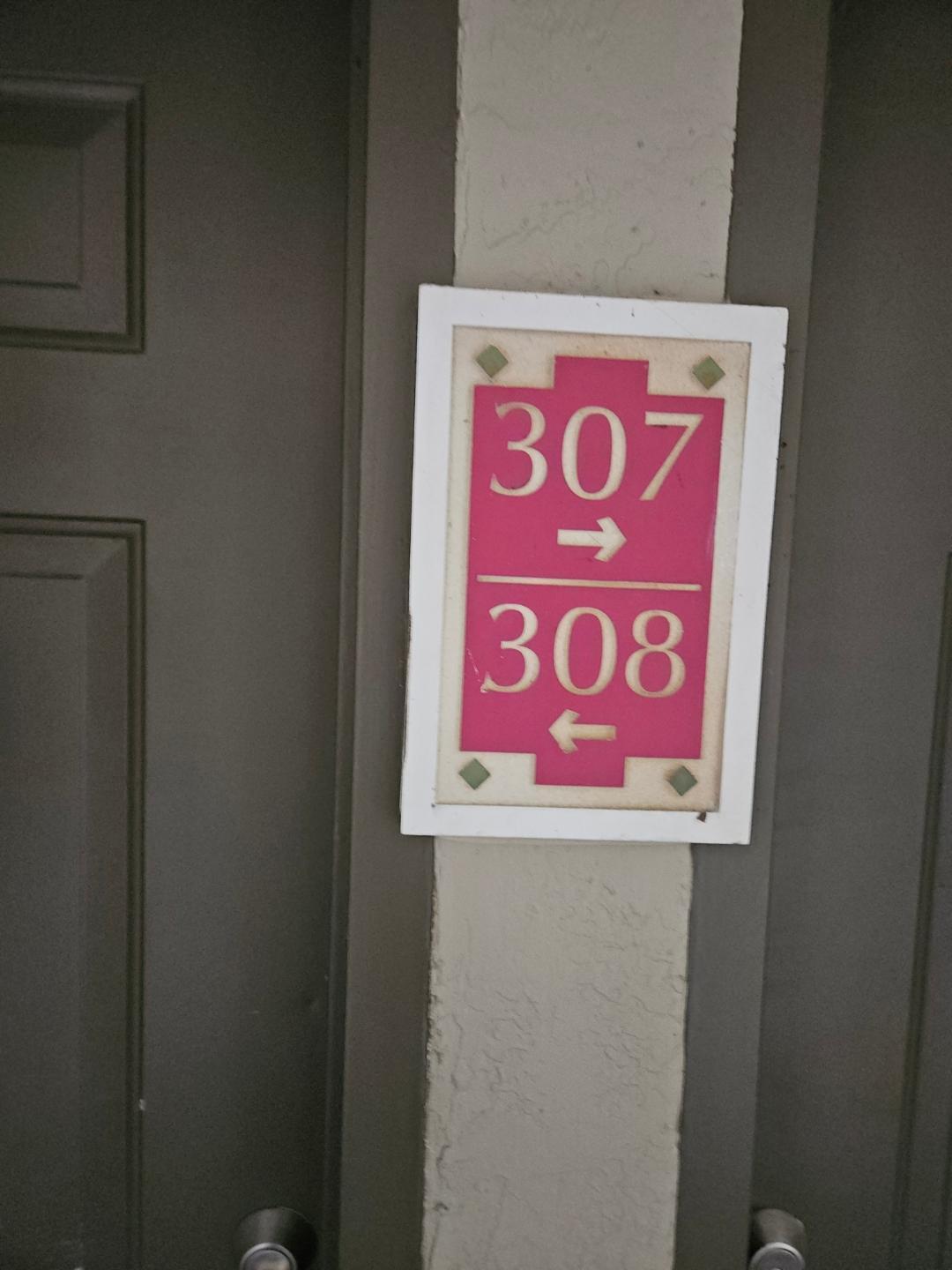 5011 Wiles Road, Unit 308 Coconut Creek, FL 33073 - Photo 1 of 12 a sign that is on a wall