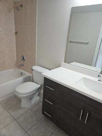 a bathroom with a sink a toilet and bathtub