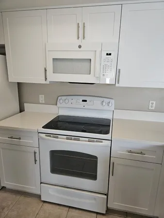 a stove top oven sitting inside of a kitchen