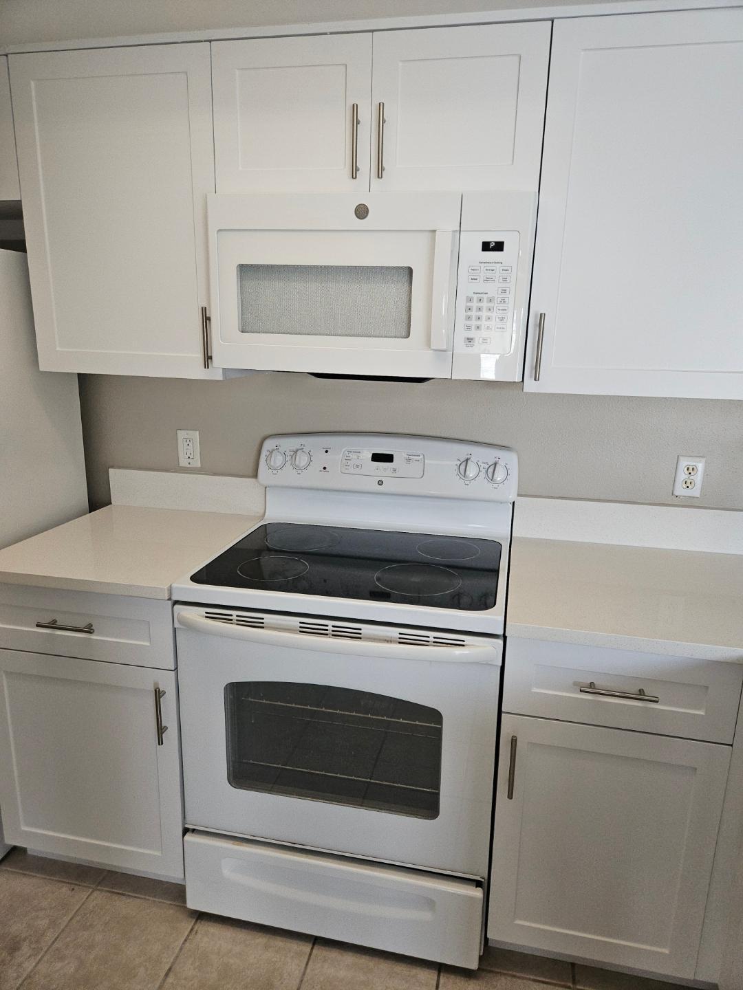 5011 Wiles Road, Unit 308 Coconut Creek, FL 33073 - Photo 8 of 12 a stove top oven sitting inside of a kitchen