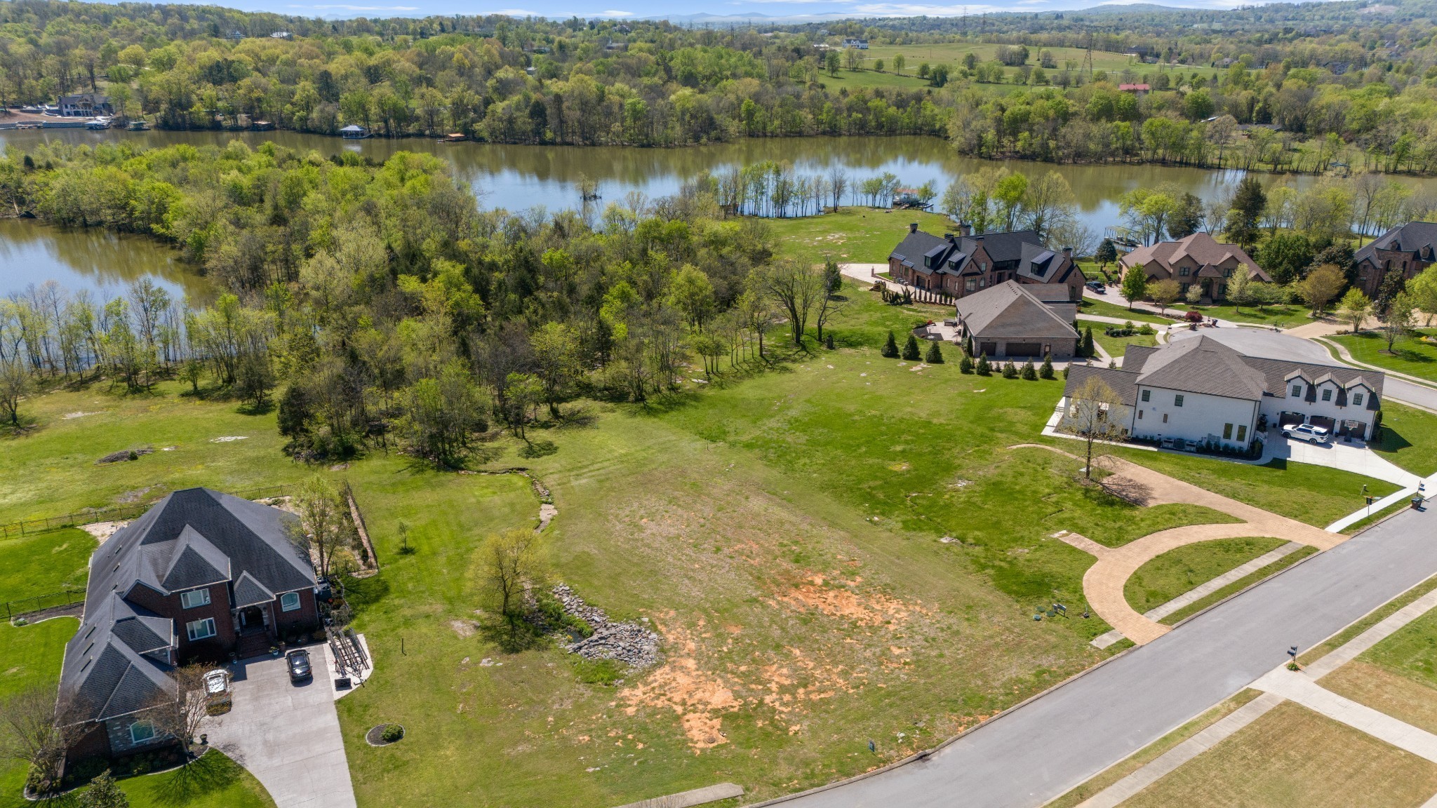 304 Stonebrook Point Lebanon, TN 37087 - Photo 4 of 8 a view of a lake with a yard and mountain view