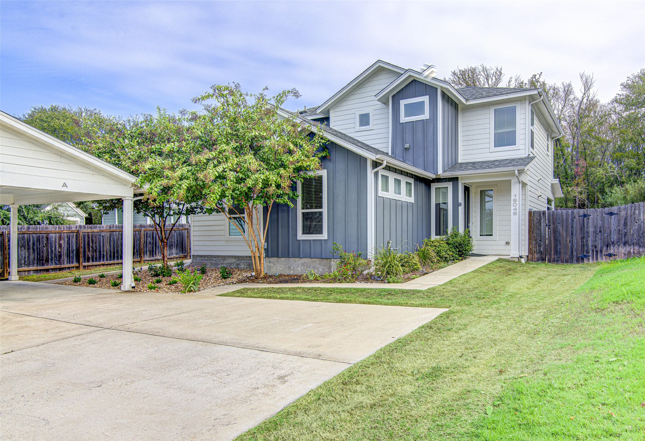 1904 Bunche Road, Unit B Austin, TX 78721 - Photo 1 of 29 Front exterior with a landscaped yard, mature trees, and a private walkway leading to the entry.