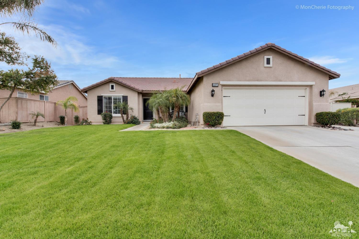 41675 Front Hall Road Bermuda Dunes, CA 92203 - Photo 1 of 23 a front view of a house with a yard and garage