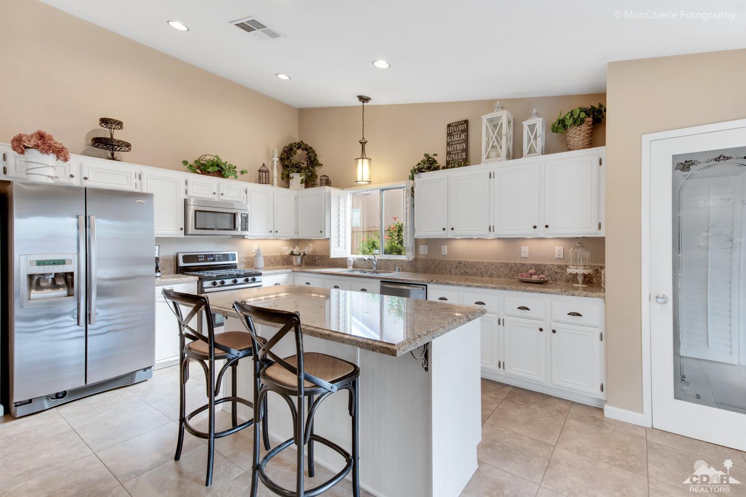 41675 Front Hall Road Bermuda Dunes, CA 92203 - Photo 2 of 23 a kitchen with stainless steel appliances kitchen island granite countertop a sink and cabinets