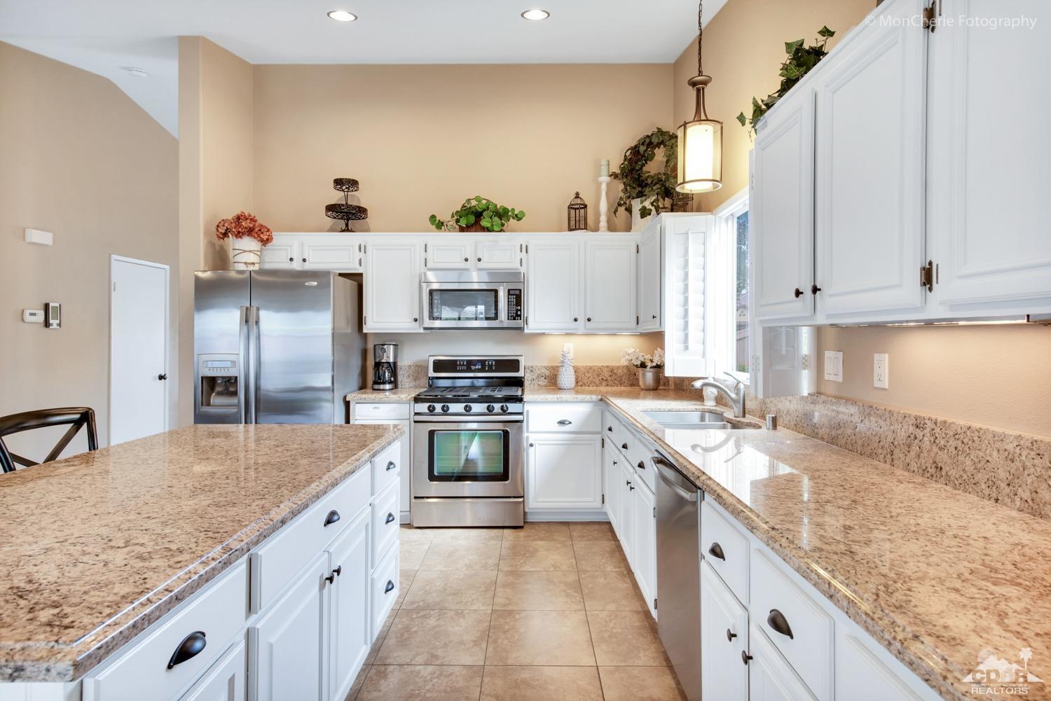 41675 Front Hall Road Bermuda Dunes, CA 92203 - Photo 6 of 23 a kitchen with stainless steel appliances granite countertop a sink stove and refrigerator