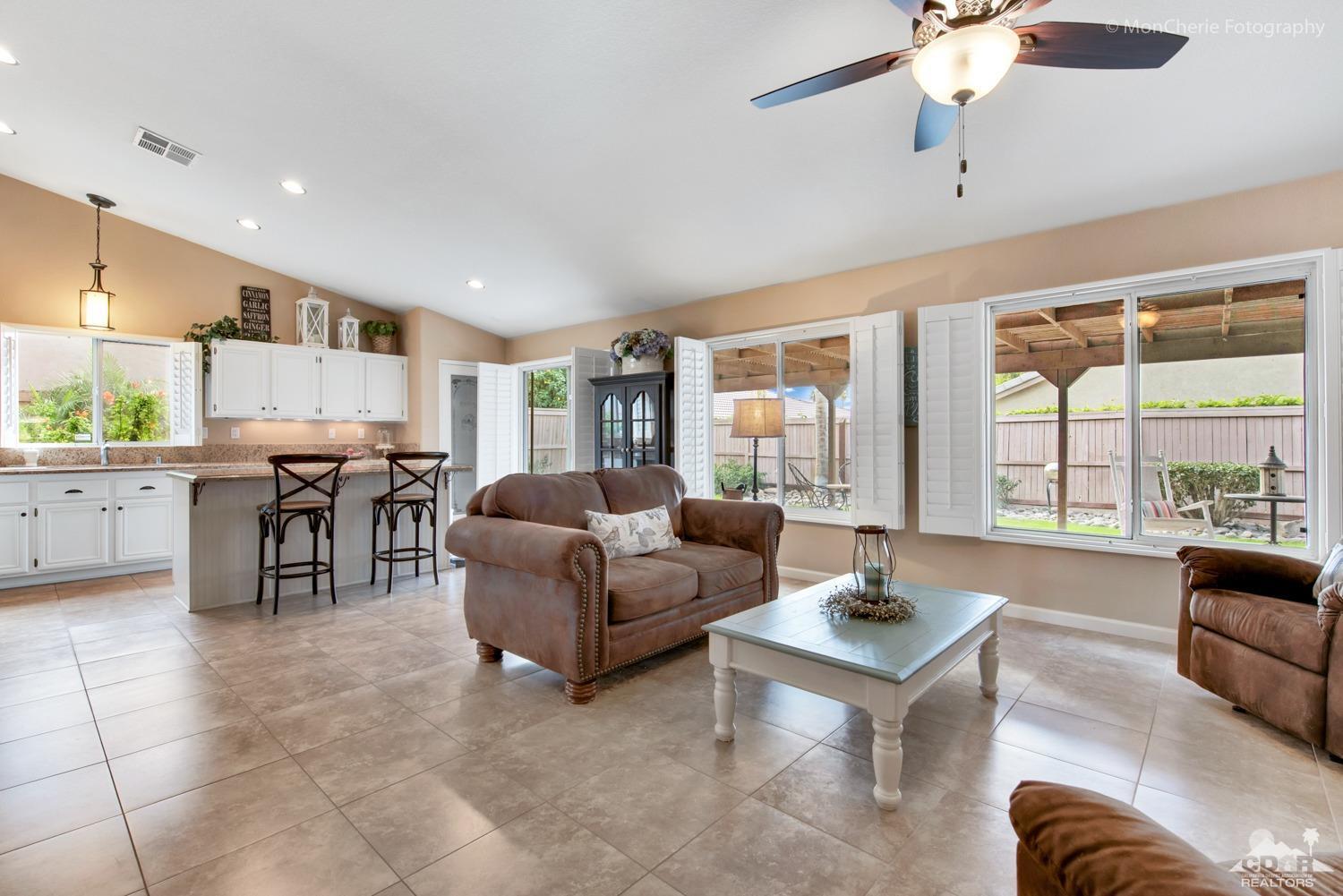 41675 Front Hall Road Bermuda Dunes, CA 92203 - Photo 9 of 23 a living room with furniture and a large window with kitchen view