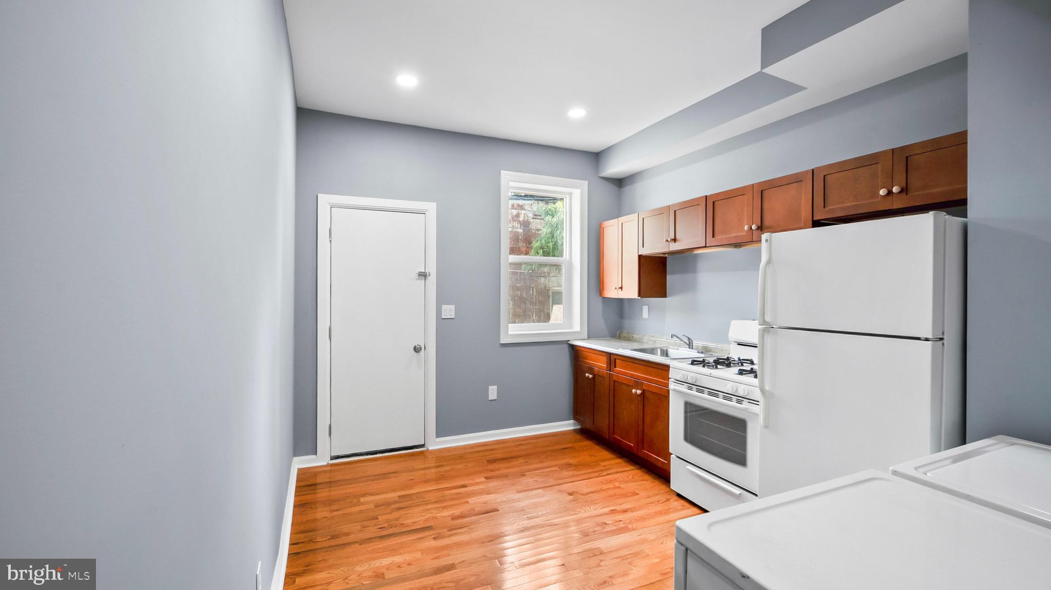 1919 Mosher Street Baltimore, MD 21217 - Photo 7 of 21 a kitchen with stainless steel appliances a refrigerator and a stove