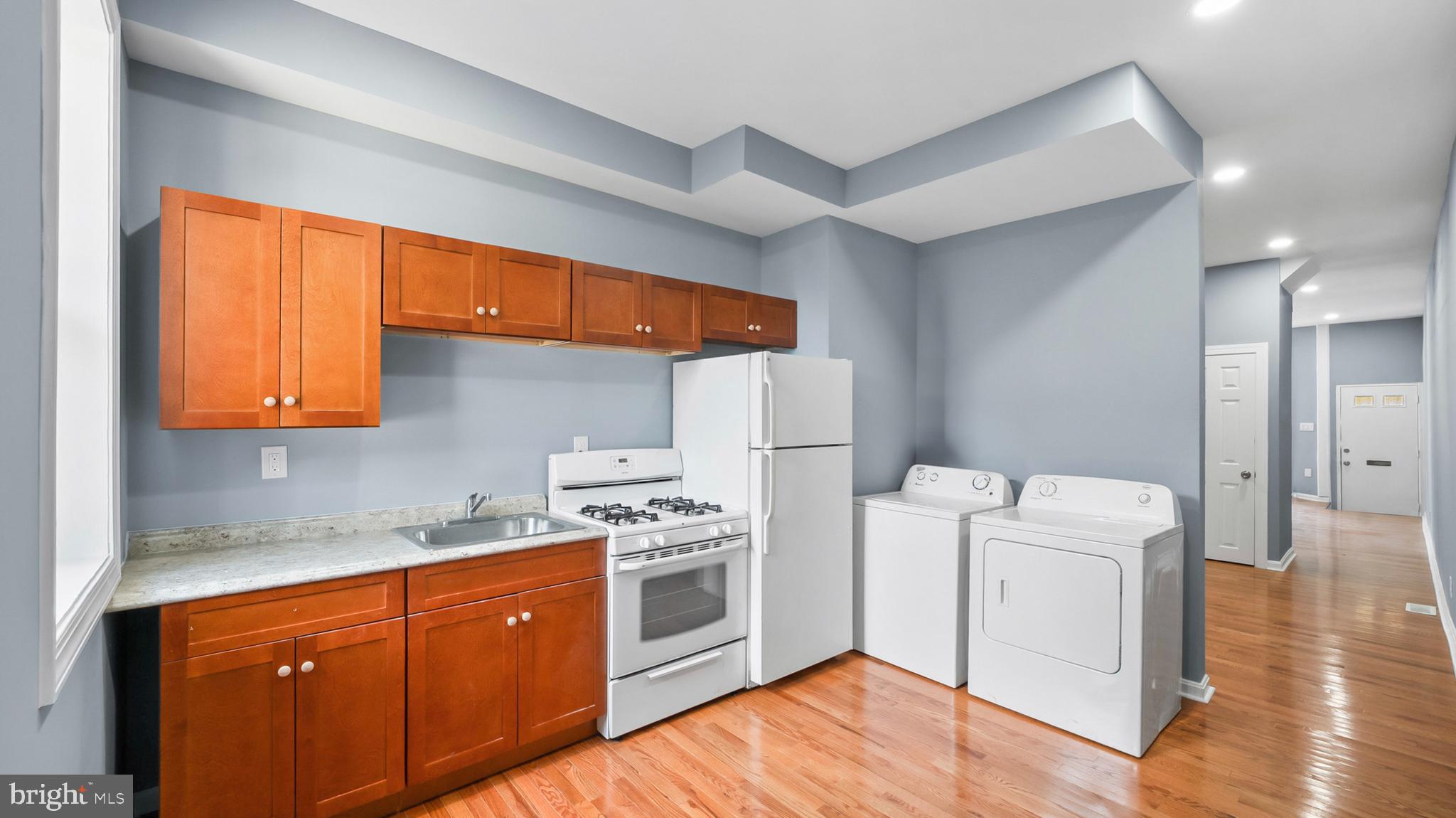 1919 Mosher Street Baltimore, MD 21217 - Photo 8 of 21 a kitchen with a stove a sink and a refrigerator
