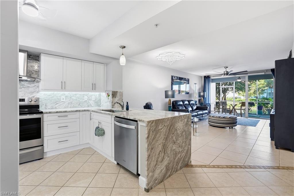 4950 Deerfield Way, Unit 103 Naples, FL 34110 - Photo 13 of 39 a kitchen with a cabinets and counter space