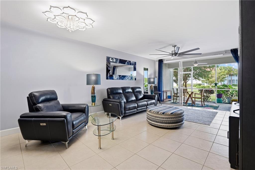 4950 Deerfield Way, Unit 103 Naples, FL 34110 - Photo 14 of 39 a living room with furniture and a large window