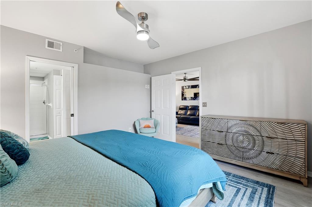 4950 Deerfield Way, Unit 103 Naples, FL 34110 - Photo 20 of 39 a bedroom with a bed and furniture