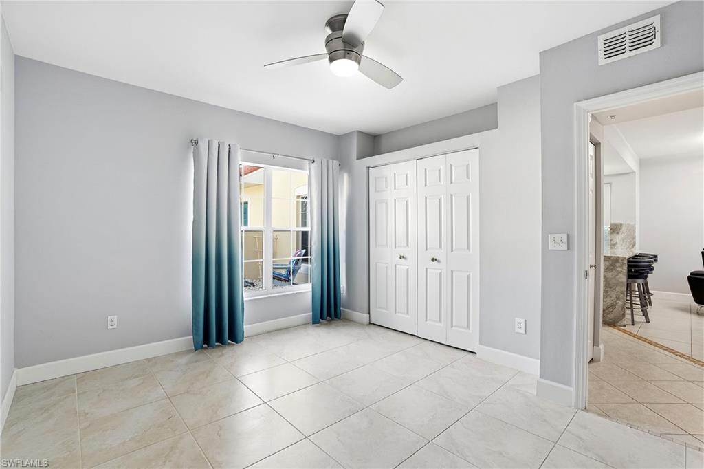 4950 Deerfield Way, Unit 103 Naples, FL 34110 - Photo 23 of 39 a view of an empty room with a window